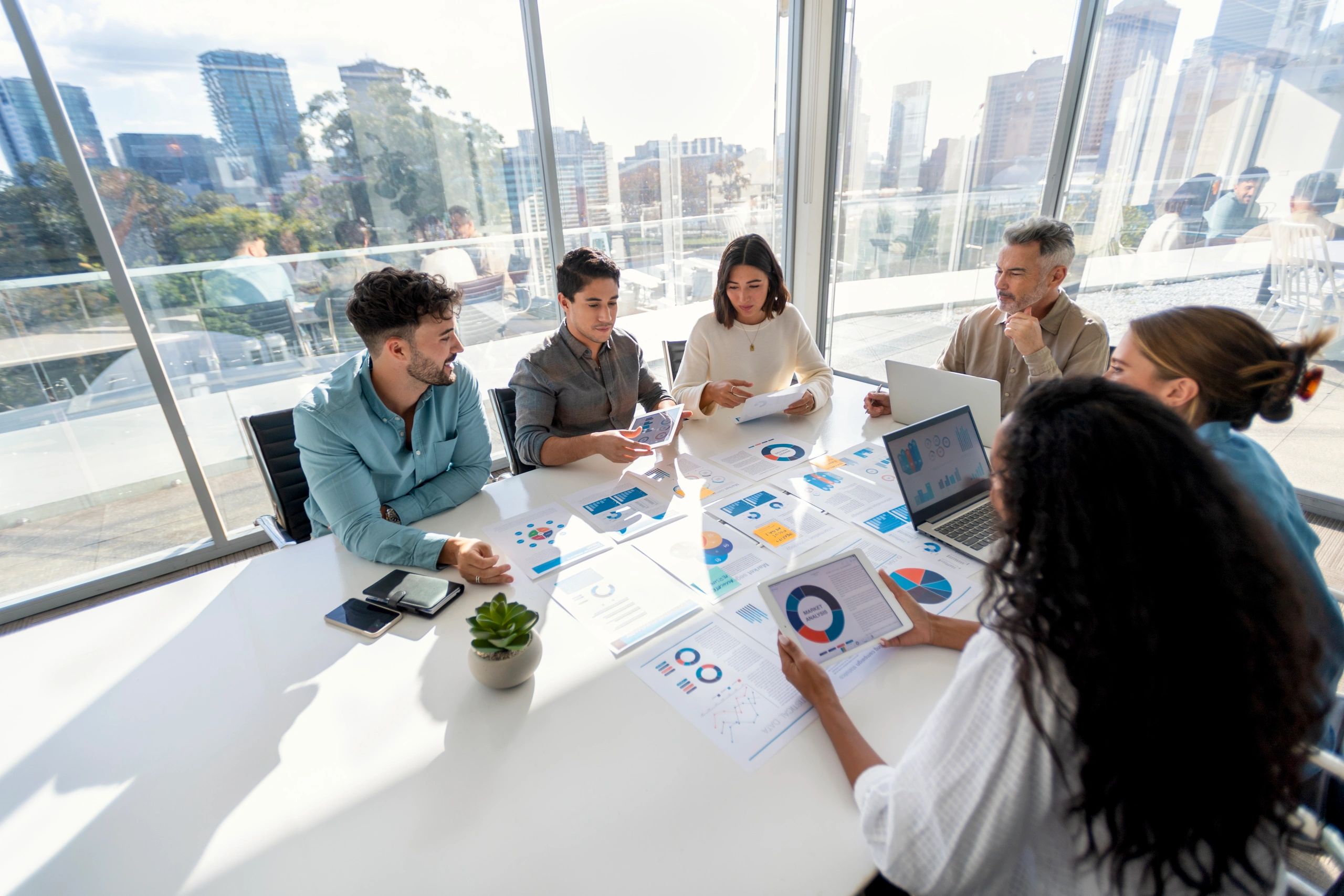 Marketing consulting team reviewing performance charts during a strategy meeting